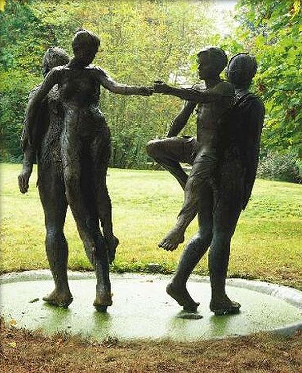 Double Dream bronze statues of a women and a man holding hands while being carried on the backs of two people walking away from eachother